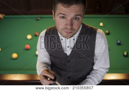 The young handsome caucasian man with cue close up