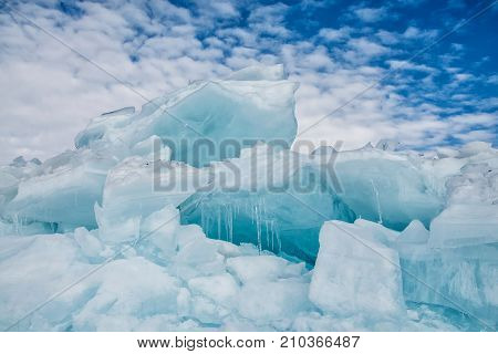 Endless blue ice hummocks in winter on the frozen Lake Baikal. Russia