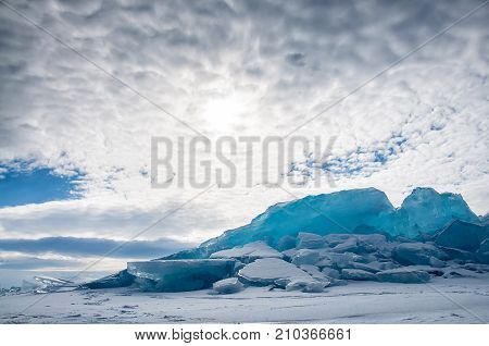 Endless blue ice hummocks in winter on the frozen Lake Baikal. Russia