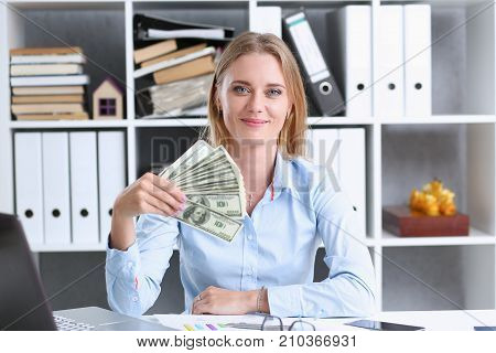 Beautiful businesswoman portrait. Scattering money notes dollars in fashion vows style  curly hair with white locks eye view of the camera