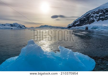Big Blue Piece Of Iceberg With Lagoon In The Background, Neco Bay, Antarctica