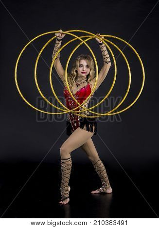 The Contortionist Girl In Stage Costume With Hoops.