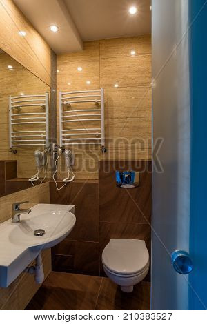 White washbasin with mirror toilet bowl dryer in the combined bathroom.