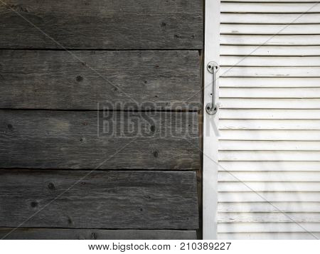 White upvc plastic door and old wooden wall outdoor cropped shot