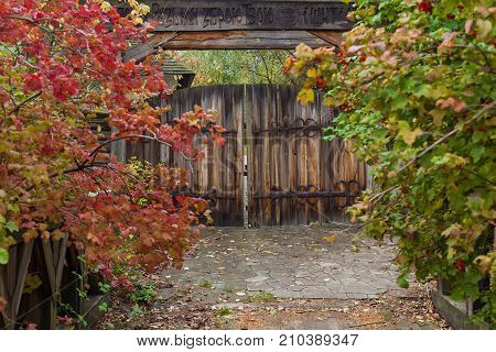 Old wooden doors with wrought iron hinges and locks. Forged metal hinges on the wood doors. Mamaev Sloboda