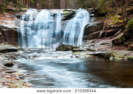 Autumn view of the Mumlava River. Krkonose National Park in the Czech Republic. Waterfall on the river