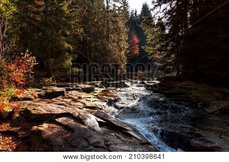 Autumn view of the Mumlava River. Krkonose National Park in the Czech Republic. Waterfall on the river