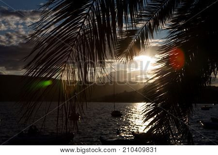 boats and yachts docked at the pier in the Bay of Montenegro at sunset and mountains in the background