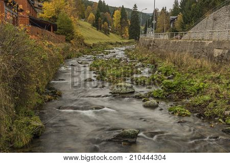 Upa River In Velka Upa Village In Krkonose Mountains With Color Autumn
