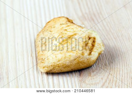 A Piece Of Apple Oxidized With Time. Photo Close-up Of A Piece Of Apple Lying On A Wooden Table