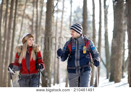 Young couple in love hiking on mountain together 