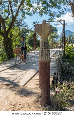 Vang Vieng, Laos - January 19, 2017: Unexploded bomb near the wooden bridge across Nam Song River in Vang Vieng village, Laos.