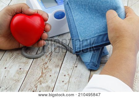 Measuring blood pressure using automatic electronic blood pressure monitor meter. Health care concept