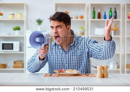 Husband with loudspeaker yelling at his wife