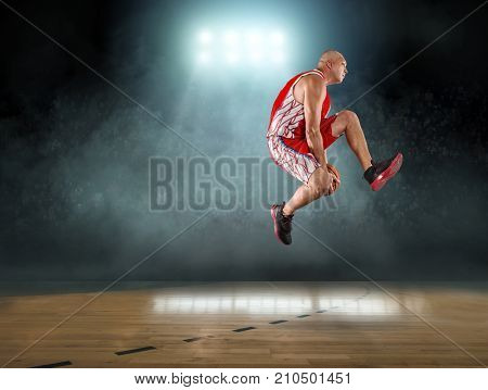 Caucassian Basketball Player in dynamic action with ball in a professional sport game