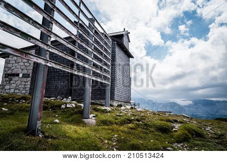 Scenic view of alps mountains a sunny day with church on foreground. Hoher Dachstein mountains.
