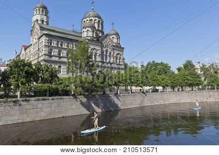 St. Petersburg, Russia - June 17, 2017: Sapsurfing along the Karpovka River against the background of St. John's Convent in St. Petersburg