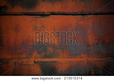 Background with blank space. The texture of the metal partially painted in orange. Abstract background in grunge style