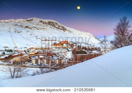 Stunning winter moonlight landscape and ski resort in French Alps, Alpe D Huez, France, Europe