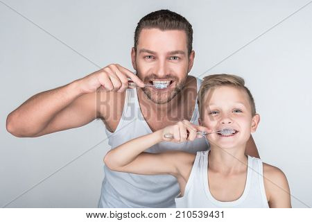 Father And Son Brushing Teeth