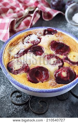 Red plums clafoutis icing sugar dressing french cuisine