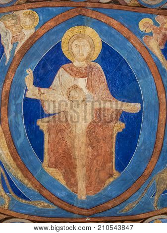 God Father holding Christ on the cross a romanesque wall-painting in Bjaresjo church Sweden November 6 2009