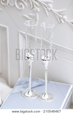 Stylish wedding decorated glasses on the table with silk blue stripes. Vera wang style. Close up