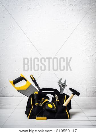 bag with repair tools on white background