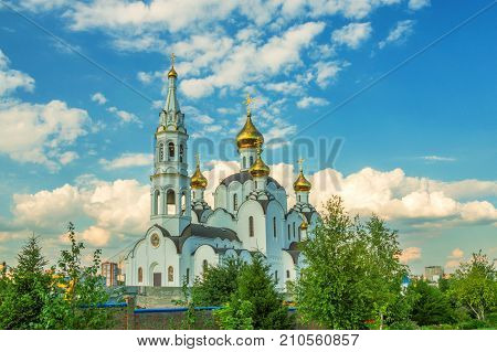 Russian Orthodox church with golden domes on sunny day