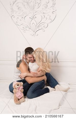 Beautiful pregnant couple in love on the background. Hands of husband on the tummy of his pregnant wife. Young man tenderly stroked pregnant belly of his wife. Husband kissing pregnant belly.