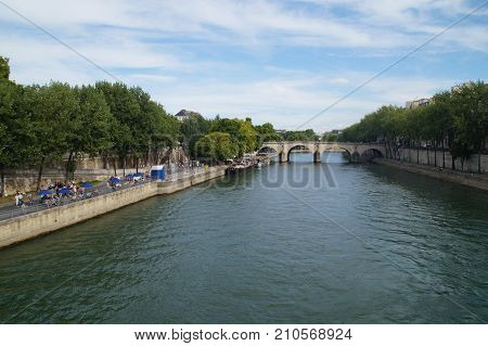 The Seine in Paris - France. The Seine in Paris is a part of the landscape of the capital of France. The Seine cuts Paris in its environment (middle) even if the right bank occupies a space more important than the left bank. 