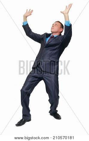 A young business man stands on bent knees and holds his hands above his head as if he is carrying something or holding it isolated on white background.