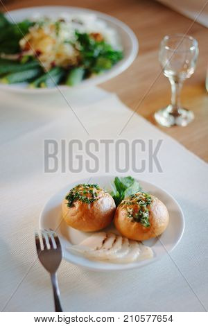 Ukarnian food - round pastries pampushki on ceramic plate