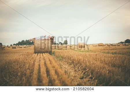 Beautiful Girl On Hay Bales In The Fields