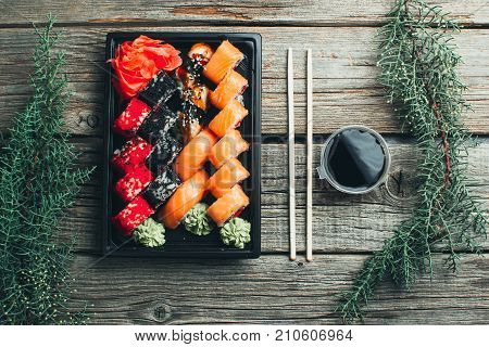 On A Wooden Table Lay In The Black Sushi Container