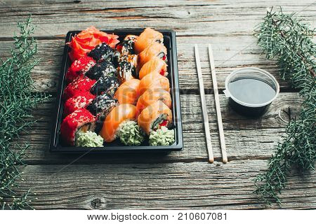On A Wooden Table Lay In The Black Sushi Container