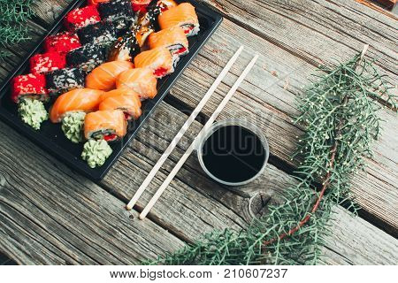 On A Wooden Table Lay In The Black Sushi Container