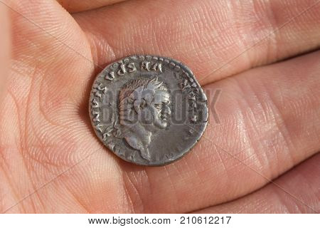 Hand Holding Roman Denarius (roman Silver Coin)