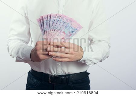 Businessman with hryvnia in his hands UAH
