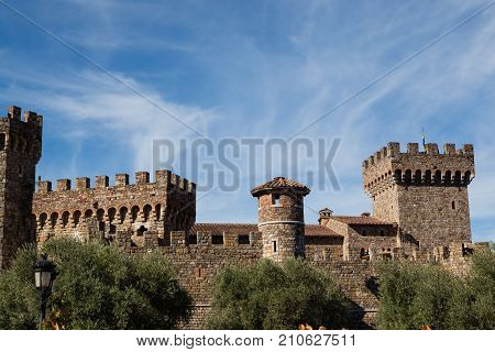NAPA VALLEY CALIFORNIA - November 8 2016 : Castello di Amorosa's turrets rising above large olive trees on November 8 2016 in Napa Valley California.