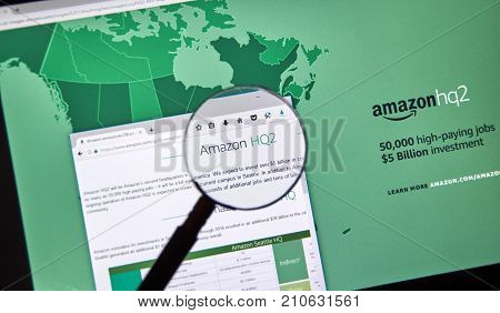 MONTREAL CANADA - OCTOBER 24 2017: Amazon second headquarter description and map on official website under magnifying glass. Amazon HQ2 will be Amazon's second headquarters in North America.