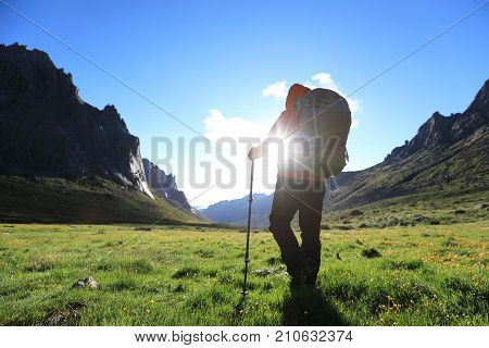 woman with backpack hiking in mountains travel lifestyle