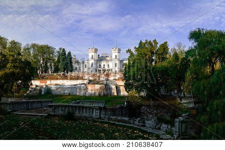 View on abandoned ruined castle and park. Autumn color image in sunset light.