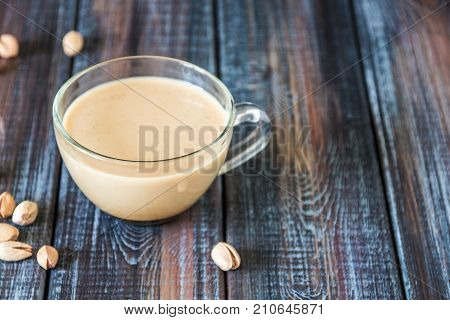 Coffee With Milk And Pistachios On The Table, Copy Space