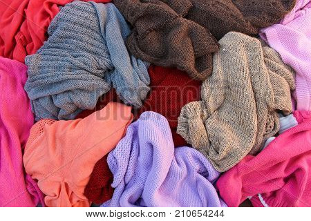 Close up pile of carelessly warm scattered clothes.