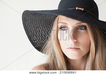 Fashionable Girl In A Hat With A Brim Poses For Advertising
