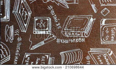 Figures book on the painted metal surface of the bookcase, which is located a park alley Nalchik. Anyone can take a book from the closet to read while walking in the park.