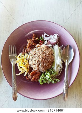Rice Seasoned with Shrimp Paste Recipe. Shrimp-paste fried rice in pastel dish.