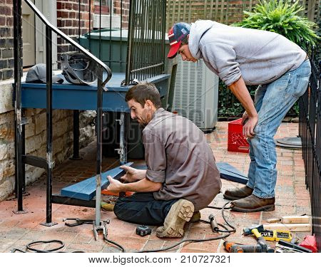 Worker Placing Bottom Step