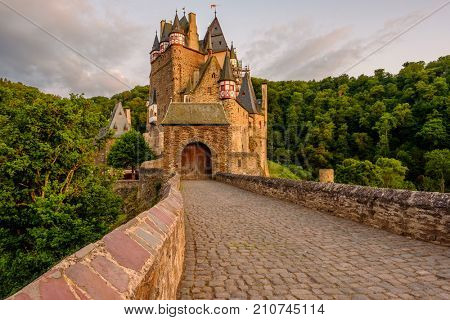 Burg Eltz castle in Rhineland-Palatinate state at sunset, Germany. Construction started	prior to 1157.